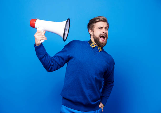 istock Portrait of man holding a megaphone 877332930