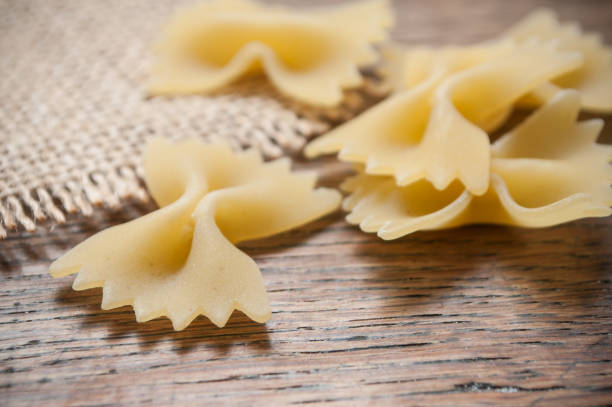 istock shaped butterfly pasta and hessian texture on wooden background 877337088