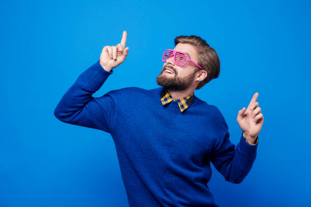Man with sunglasses dancing at studio shot