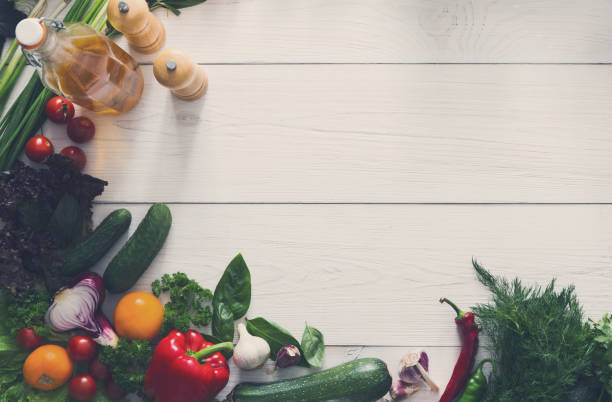 istock Fresh vegetables border on white wood background with copy space 877337488