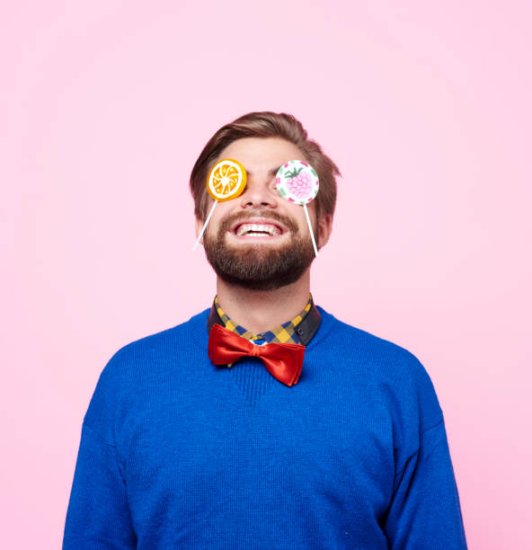 istock Eccentric man enjoying with lollipop 877337528