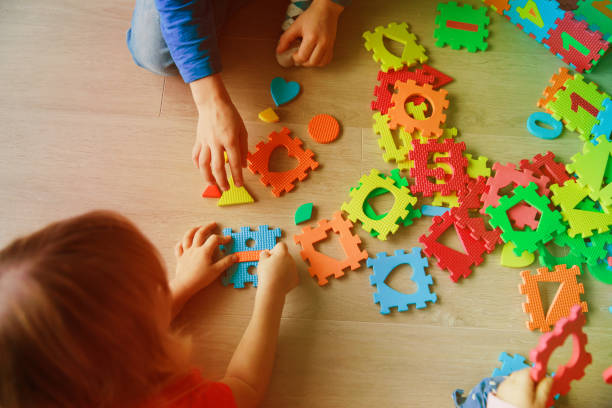 istock kids playing with puzzle, early child development 877337718