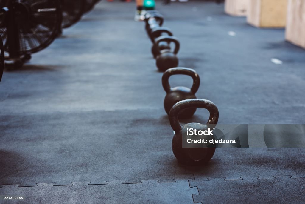 Heavy metal kettlebells weights Heavy metal kettlebells weights in the gym. Cross Training Stock Photo
