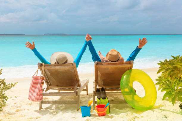istock happy couple relax on a tropical beach 877341004