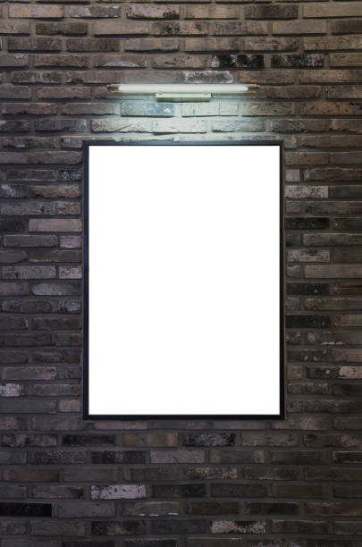Exhibition or advertising poster frame design template. Brick wall with picture frame and lights. stock photo
