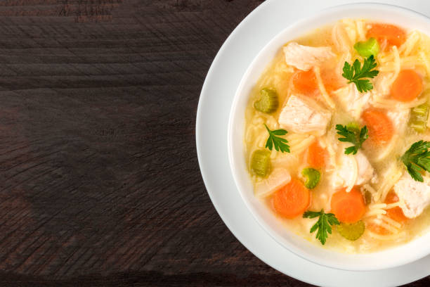 istock Chicken soup with noodles, overhead closeup photo with copyspace 877348876