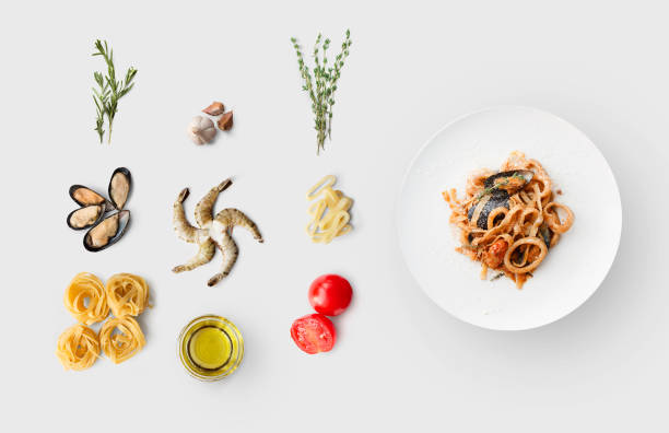 cooking ingredients for italian food, seafood pasta, isolated on white - divided plate imagens e fotografias de stock