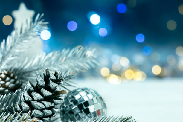istock silver christmas tree decorations on blurred garlands lights background 877349282