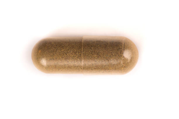 istock dark brown pill from above isolated on white 877354620