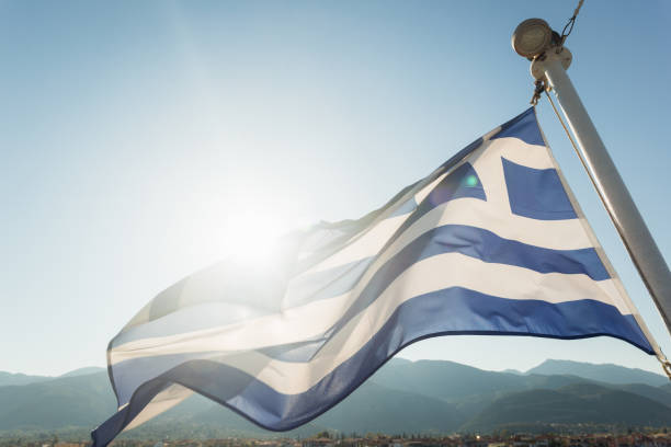 Greece Flag is Waving Against Blue summer Sky