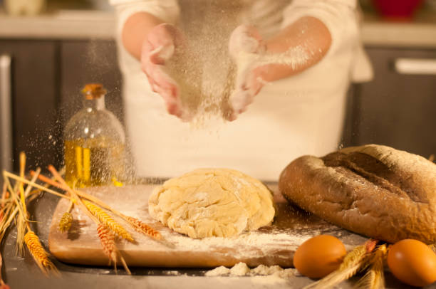 istock woman hands kneading dough 877355488