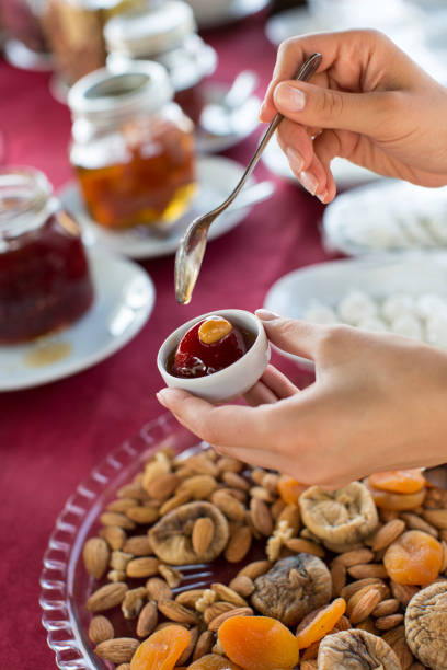 istock Woman Serving Tomato Jam for Breakfast 877357114