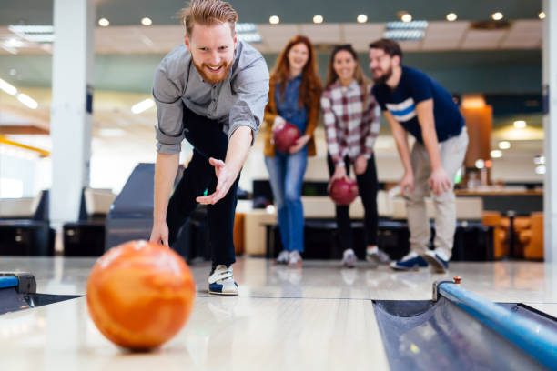 istock Friends enjoying bowling at club 877357118