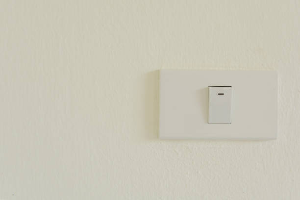 istock White light switch on wall turn on or turn off the lights, copy space 877361010