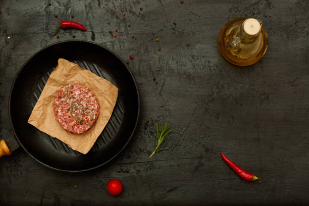 istock Raw lamb cutlet on a  grill pan 877363318