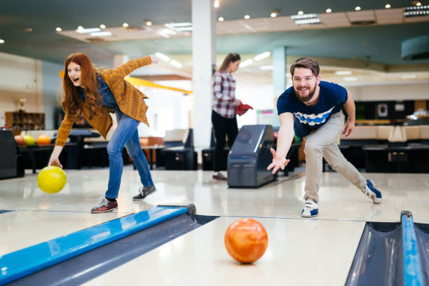 istock Friends enjoying bowling at club 877363404