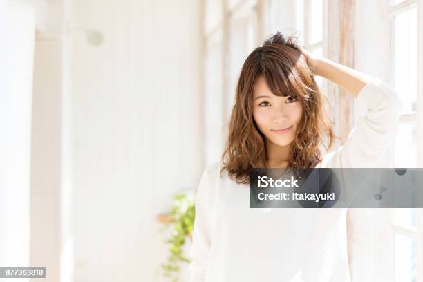 Attractive Asian Woman In Living Room Stock Photo - Download Image Now - Women, Japanese Ethnicity, Hair