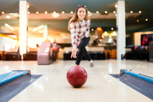 istock Woman throwing bowling ball 877364678