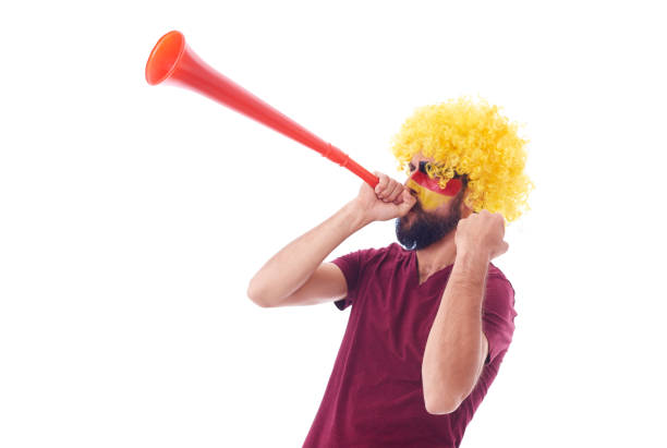 soccer fan with wig and vuvuzela celebrating - vuvuzela imagens e fotografias de stock