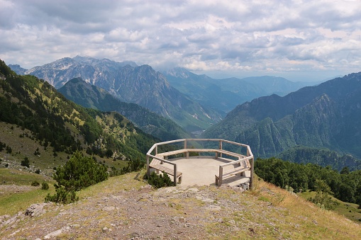 Viewing platform on the top of a mountain pass road in the Theth National Park. View of the Kelmendi mountains, said to be among the most inaccessible mountain ranges, North Albania, Southeast Europe.