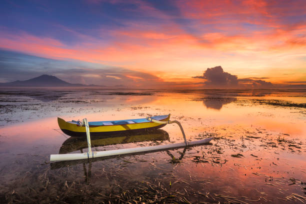 Boat at beautiful sunrise on Bali island, Indonesia stock photo