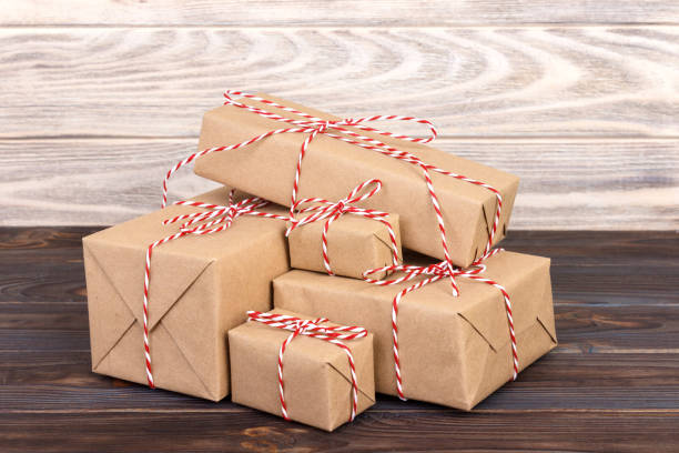 istock Image of handmade gift boxes on wooden table 877370690