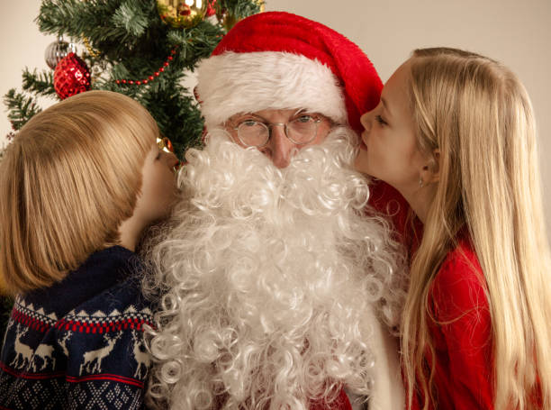 istock Children whispering to Santa Claus 877372414