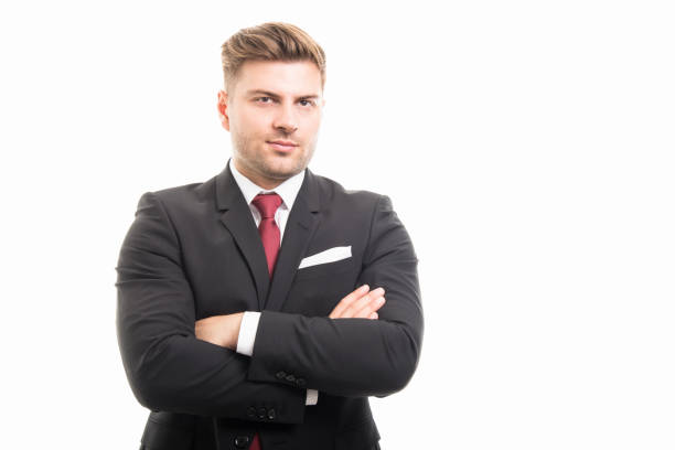 istock Handsome business man standing with arms crossed 877374348