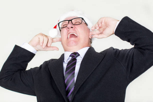 istock Furious businessman covering ears and screaming 877380974