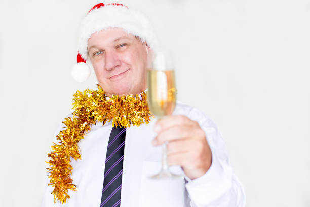 uomo bello contento che beve champagne alla festa - party business toast champagne foto e immagini stock