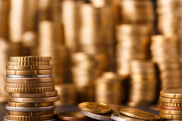 istock Golden coin stacks, rich money background 877381376