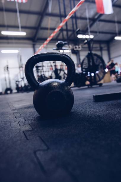 istock Heavy metal kettle bell weight on the floor 877383094