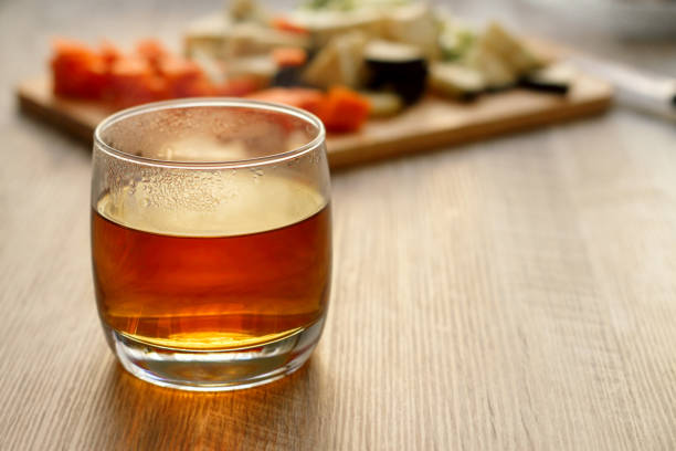 istock Tea in a glass on a wooden table 877383646