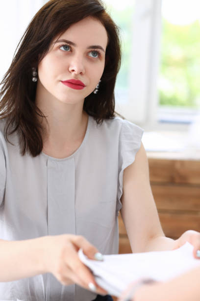 istock Female employee show pack of documents 877384276