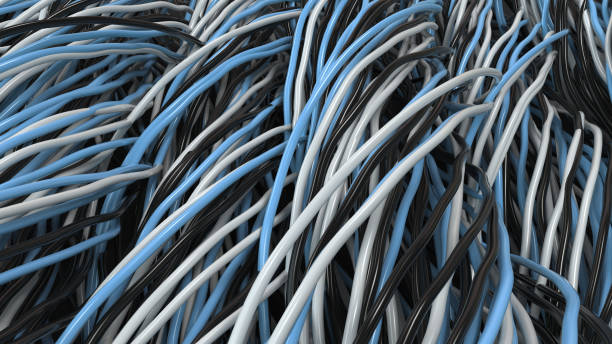 istock Twisted black, white and blue cables and wires on black surface 877385970