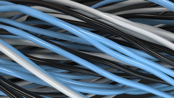 istock Twisted black, white and blue cables and wires on black surface 877386140