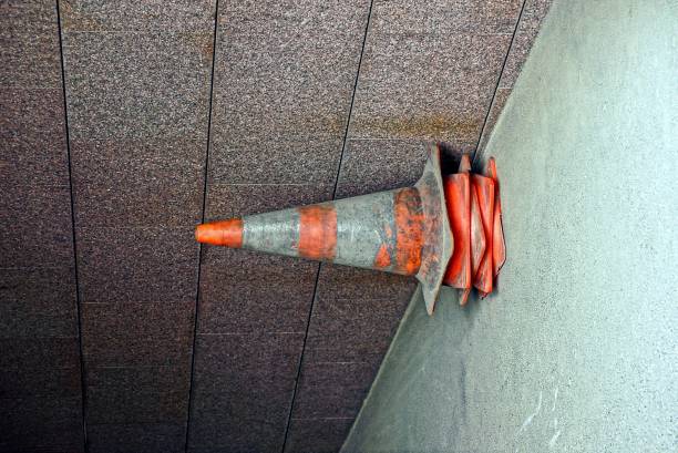 istock Traffic cones limiter in a pile near a wall 877394714