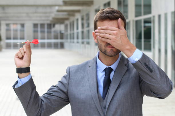 istock Blind businessman holding a dart 877405720