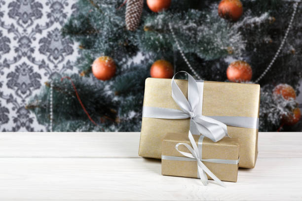 istock Christmas presents on decorated tree background, holiday concept 877414768