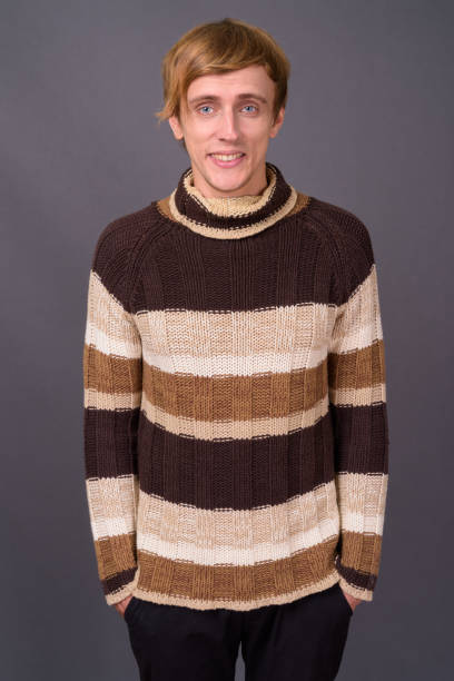 istock Young handsome man with bond hair against gray background 877441890