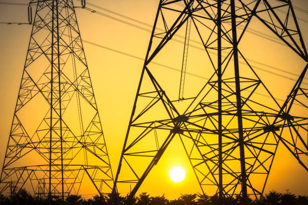 istock Electricity station. Close up high voltage power lines at sunset. 877471218
