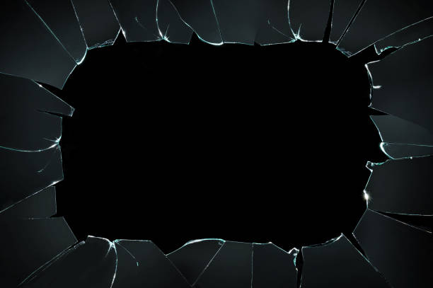 istock broken cracked glass with big hole over black background 877474776