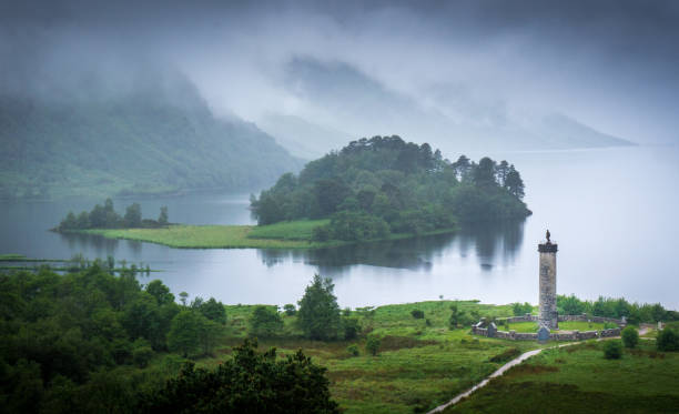 Glenfinnan Monument The Glenfinnan Monument at the shore of a loch in Scotland glenfinnan monument stock pictures, royalty-free photos & images