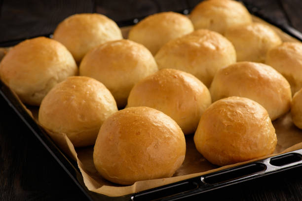 istock Homemade potato bread rolls on wooden tray. 877494018