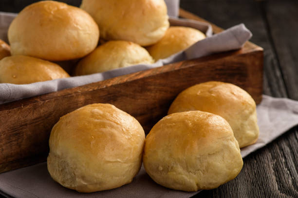 Homemade potato bread rolls on wooden tray. stock photo