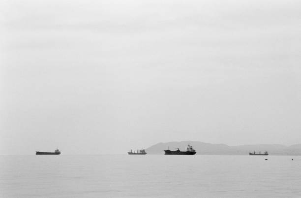 Sailboats sailing Ahead of the Storm over the Atlantic Ocean captured in black and white