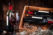 Wine bottles and wineglass shot rustic wooden table