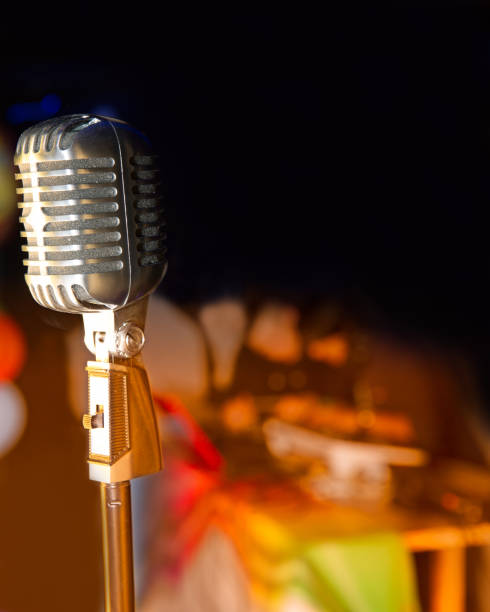 istock Retro style microphone on stage in the spotlight 877497500
