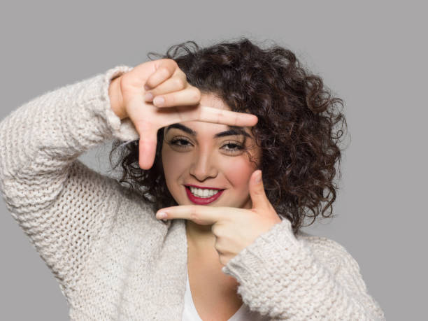 istock Young woman framing herself 877498146
