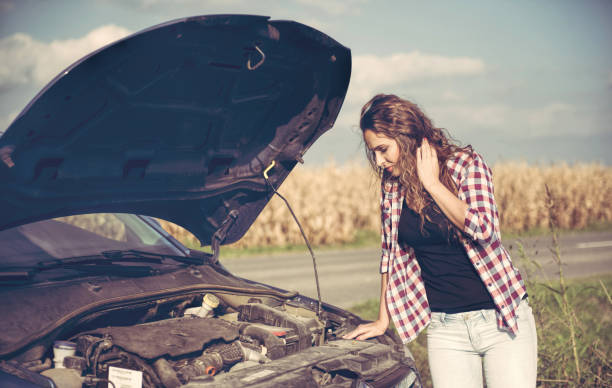 istock Beautiful young woman is a problem with the car 877500326